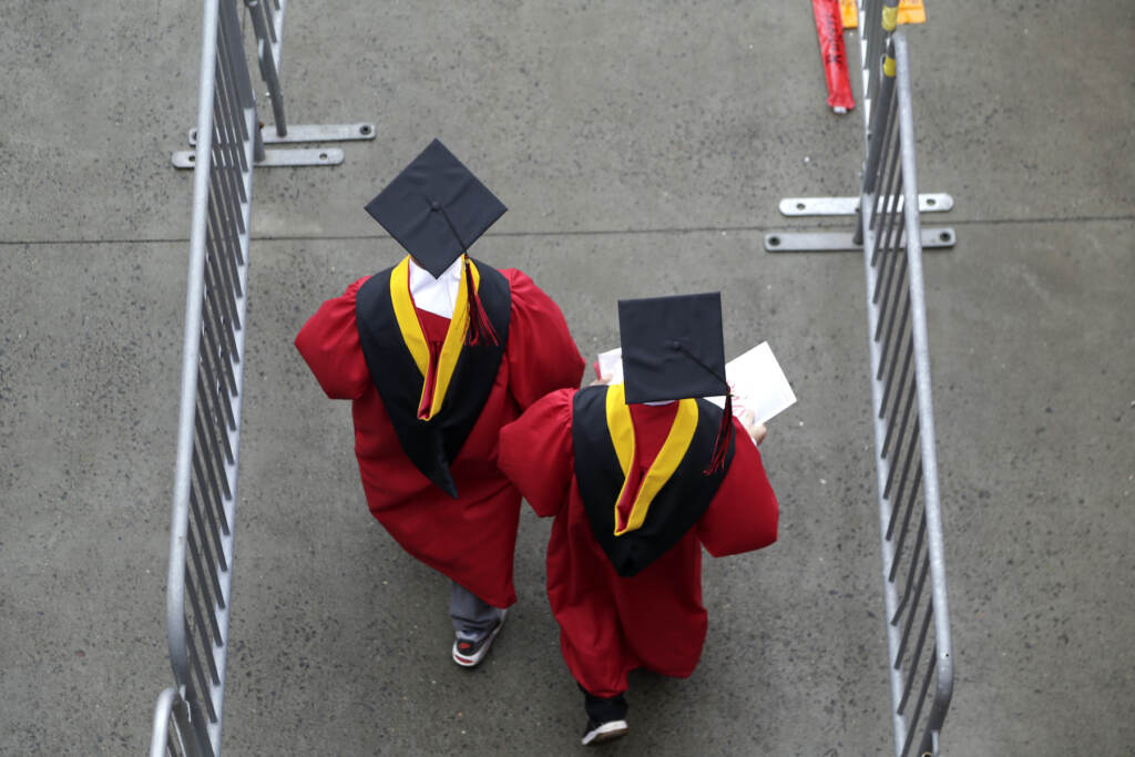 Supreme Court Student Loans Explainer FILE - New graduates walk into the High Point Solutions Stadium before the start of the Rutgers University graduation ceremony in Piscataway Township, N.J., on May 13, 2018. The Supreme Court is about to hear arguments over President Joe Biden’s student debt relief plan. It's a plan that impacts millions of borrowers who could see their loans wiped away or reduced. (AP Photo/Seth Wenig, File)