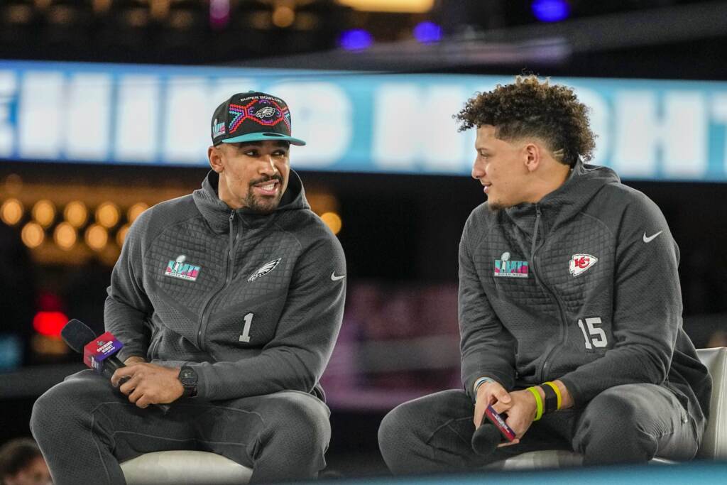jalenhurts-patrickmahomes-scaled Jalen Hurts and Patrick Mahomes speak on stage.