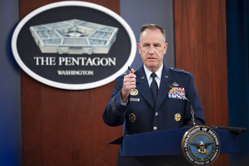 Patrick Ryder A man in uniform speaks from a podium.
