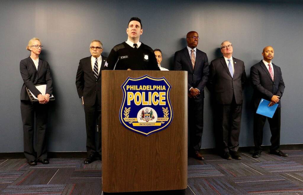 press-conference-death-officer-fitzgerald A group of people stand behind a podium with a sign that reads Philadelphia Police.
