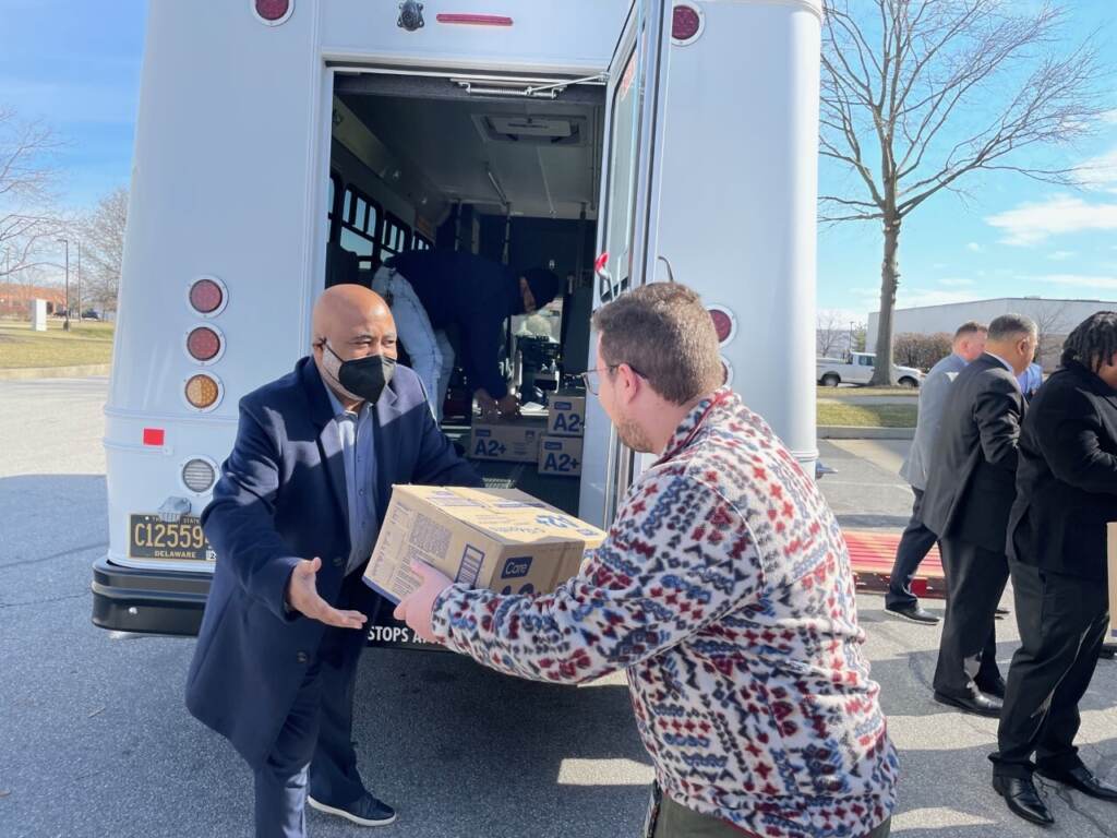rep cooke loading truck State Rep. Franklin Cooke (left) loads a box of baby formula onto a truck with an unidentified volunteer