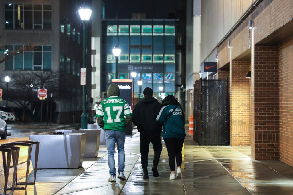 Sad fans walk home after the Philadelphia Eagles lose the Super Bowl