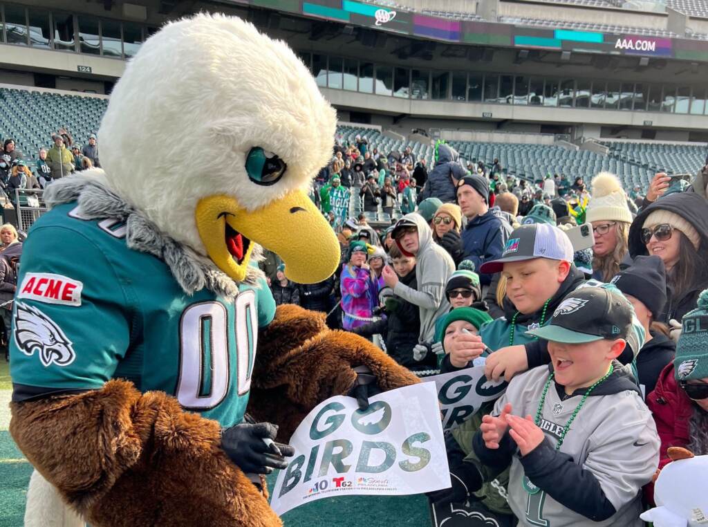 swoop-eagles-sendoff-h-holiday Philadelphia Eagles mascot Swoop signs an autograph for a young Eagles fan during the Philadelphia Eagles Super Bowl Send-off Party. (Jetta M. Holiday/WHYY)