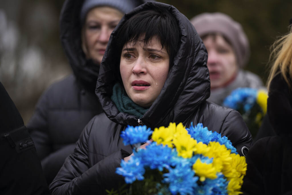 Russia Ukraine War A woman crying and holding flowers