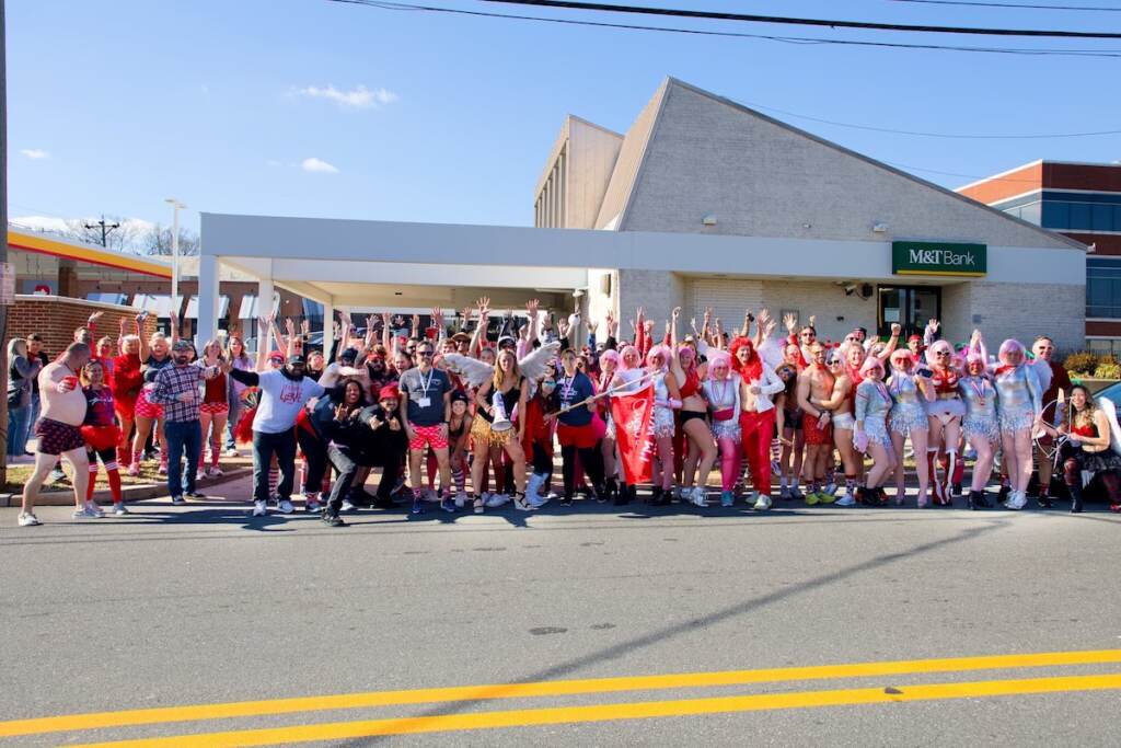 wilmington-cupid-fun-run-1 A group of people wearing red pose for a photo on a street.