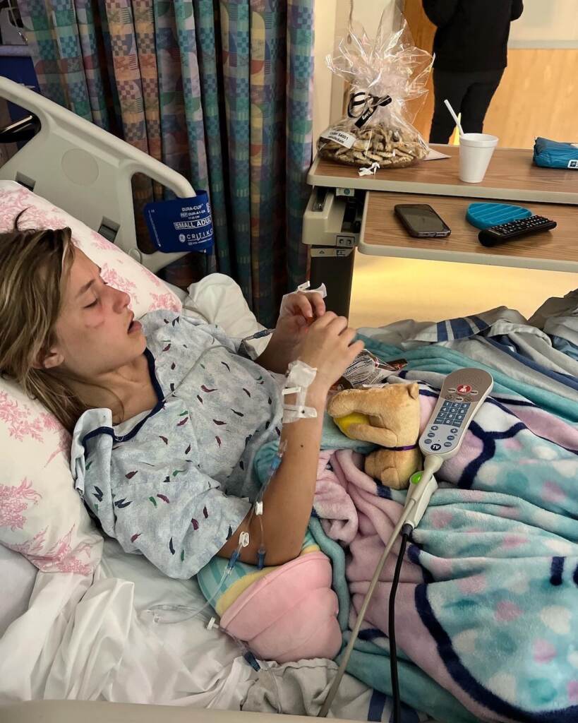 A girl is lying in a hospital bed.