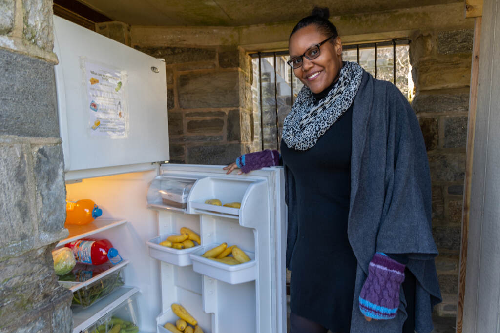 03 08 2023 k paynter nicole williams with community fridge Nicole Williams smiles, posing for a photo next to the open door of the community fridge.