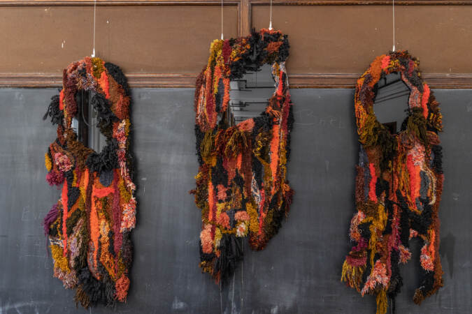 A tufted artwork is on display.