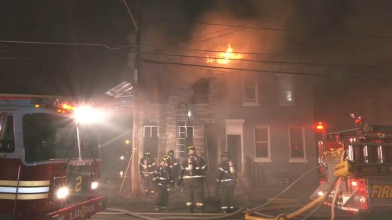 Firefighters attempt to control the Camdem home that Dr. Martin Luther King spent time in.