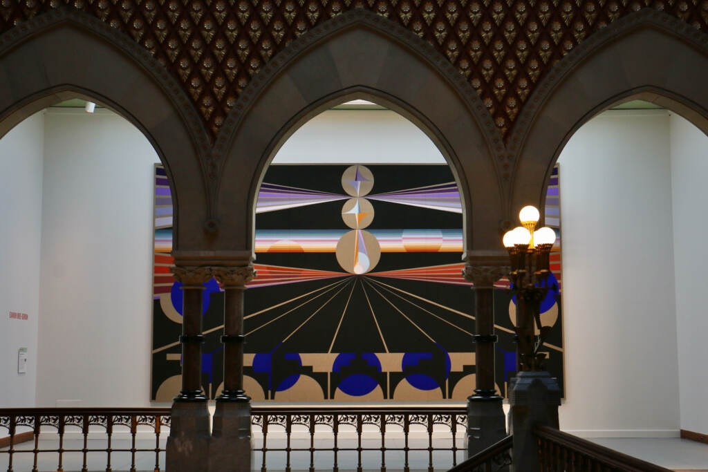 Paintings are displayed on the wall.