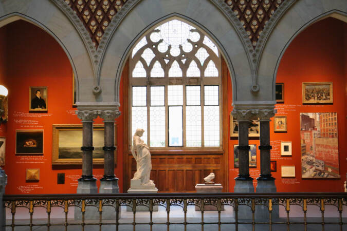 Figures are visible on display in a gallery space.