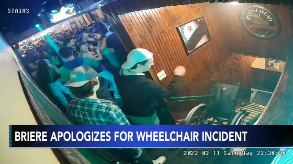 Video camera footage shows students throwing a wheelchair down the stairs at a bar.