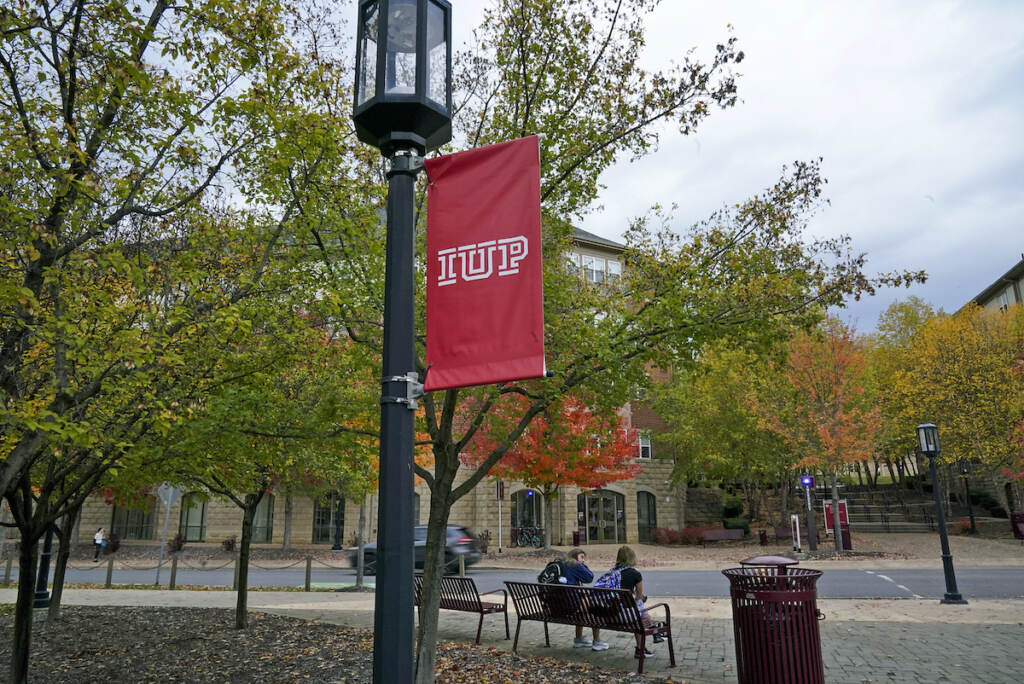 Indiana Unuversity of Pennsylvania Students sit on a bench on the campus of Indiana University of Pennsylvania in Indiana, Pa