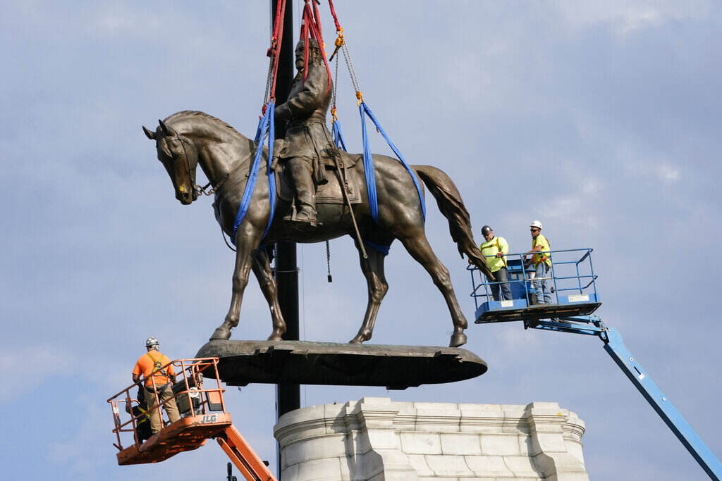 YE Reporter’s Notebook Equity Crews remove one of the country's largest remaining monuments to the Confederacy, a towering statue of Confederate General Robert E. Lee on Monument Avenue in Richmond, Va., Wednesday, Sept. 8, 2021. (AP Photo/Steve Helber, File)