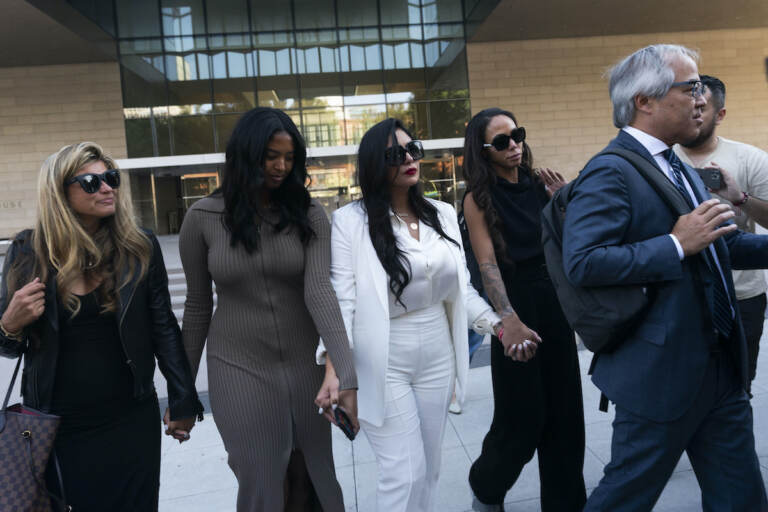 Vanessa Bryant (center) Kobe Bryant's widow, leaves a federal courthouse with her daughter Natalia (center left) soccer player Sydney Leroux (center right) in Los Angeles