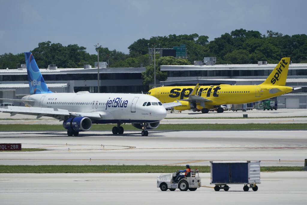 JetBlue, Spirit File photo: A JetBlue Airways Airbus A320, left, passes a Spirit Airlines Airbus A320 as it taxis on the runway, July 7, 2022, at the Fort Lauderdale-Hollywood International Airport in Fort Lauderdale