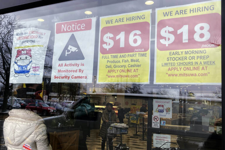 File photo: Hiring signs are displayed at a grocery store in Arlington Heights, Ill., Jan. 13, 2023. Employers are increasingly posting salary ranges for job openings, even in states where it's not mandated by law, according to analysts with employment sites Indeed, GlassDoor, and Monster. (AP Photo/Nam Y. Huh, File)