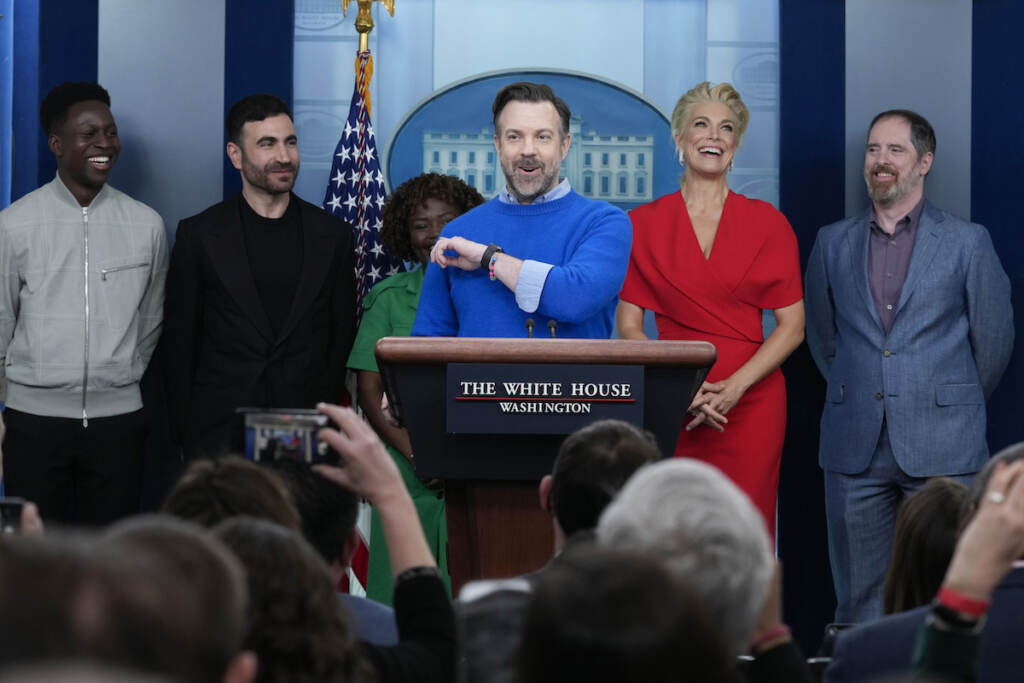Jason Sudeikis (fourth from left) who plays the title character in the Apple TV+ series ''Ted Lasso,'' speaks as he joins White House press secretary Karine Jean-Pierre (third from left) and fellow cast members (from left) Toheeb Jimoh, Brett Goldstein, Hannah Waddingham, and Brendan Hunt, during the daily press briefing at the White House in Washington