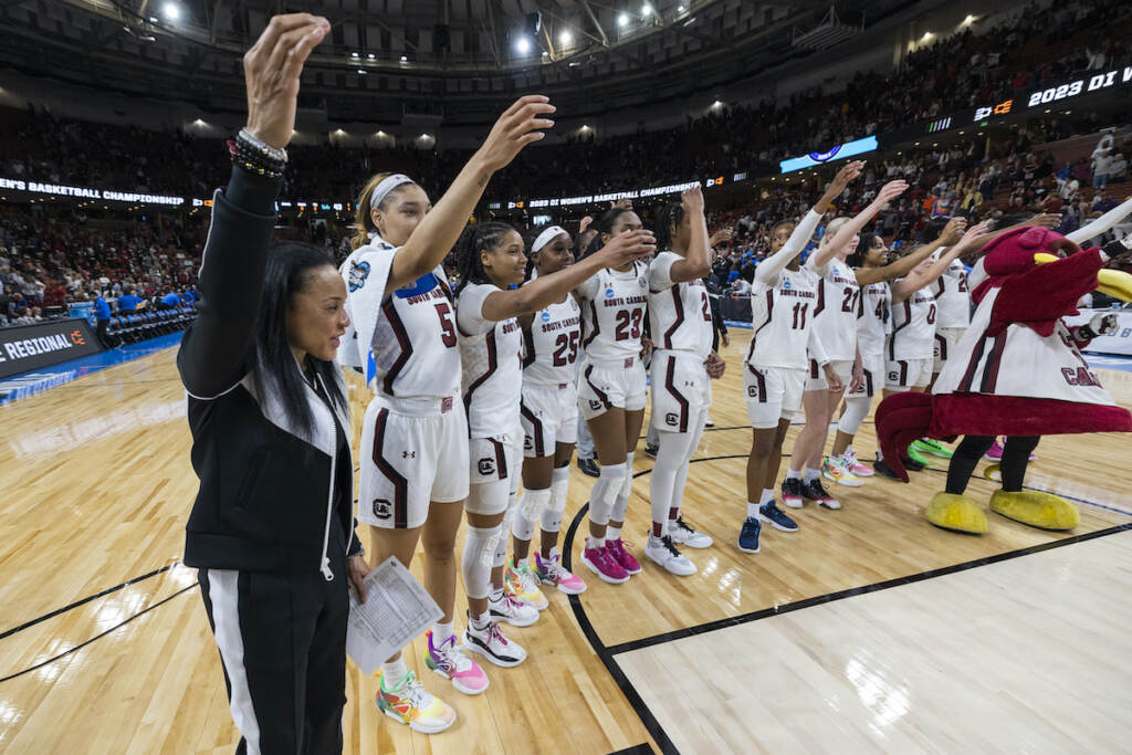 South Carolina's head coach Dawn Staley (far left) celebrates with her players after they defeated UCLA to advance to the Elite Eight following a Sweet 16 college basketball game at the NCAA Tournament in Greenville