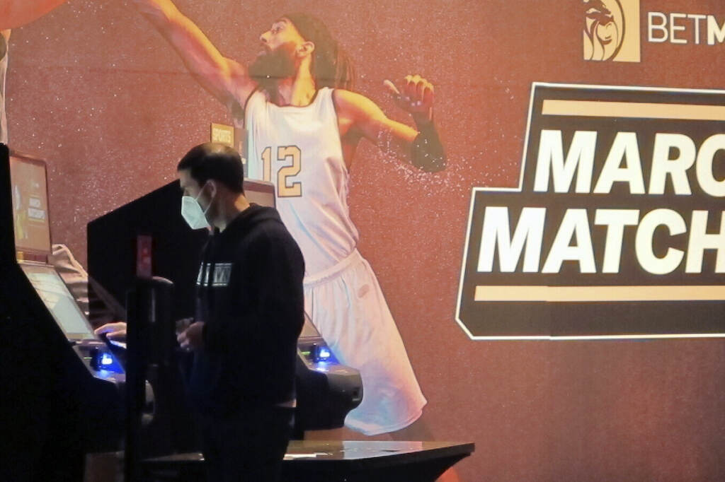 Sports Betting-Marketing A man makes a bet at a kiosk in the Borgata casino in Atlantic City NJ on March 19, 2021 at the start of the March Madness college basketball tournament