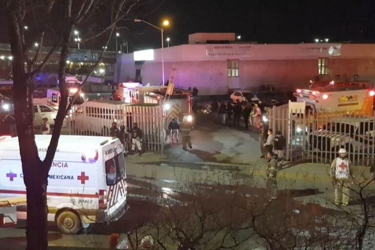 Image taken from a video showing ambulances and rescue teams staffers outside an immigration center in Ciudad Juarez, Mexico