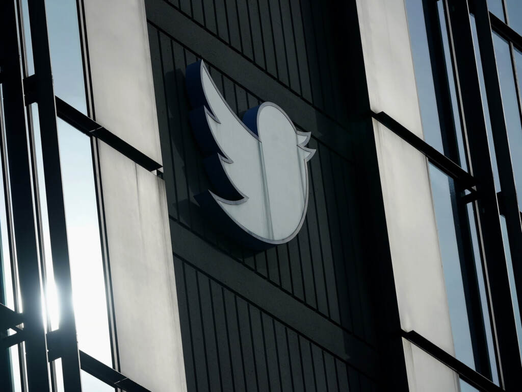 A Twitter logo hangs outside the company's offices in San Francisco