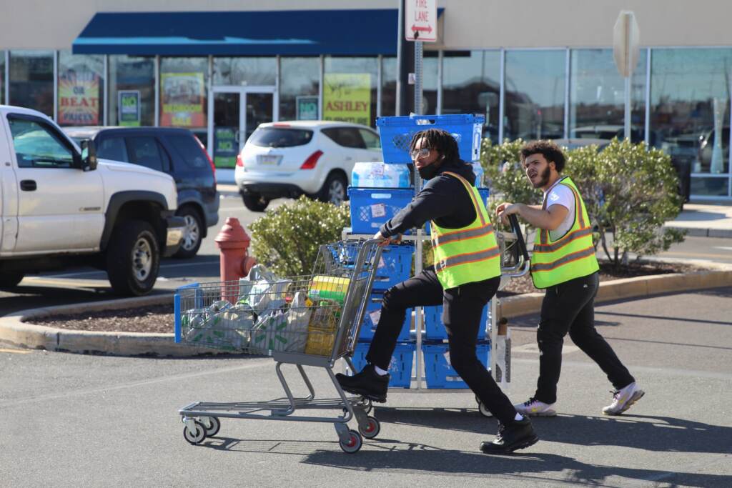 bottledwatershoppingrush-02 Workers at the Port Richmond Walmart roll more water to the store on Sunday, March 27.