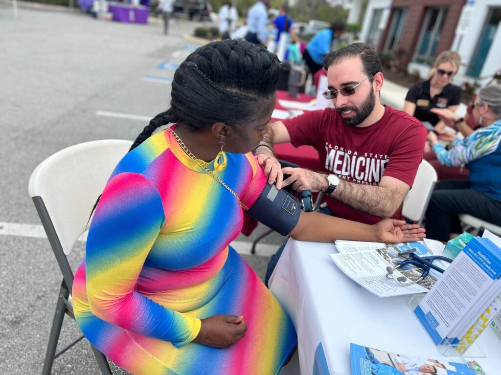 crystal-clyburn-bp_custom-ffe35c4883e2836d225a80d1c922d538f09eb2eb-s1600-c85 Crystal Clyburn has her blood pressure taken at a table outdoors.