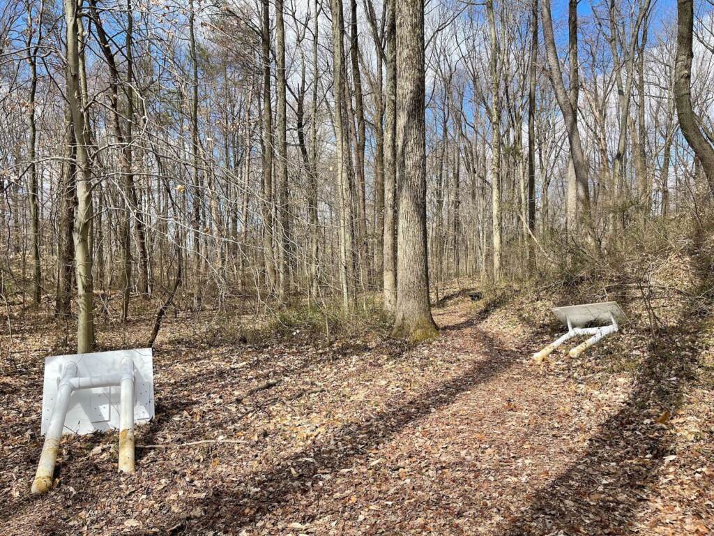 delaware-black-history-trail-vandalism-j-perez-gonzalez-2023-03-14-2 Trail signs are overturned in a trail in a forest.