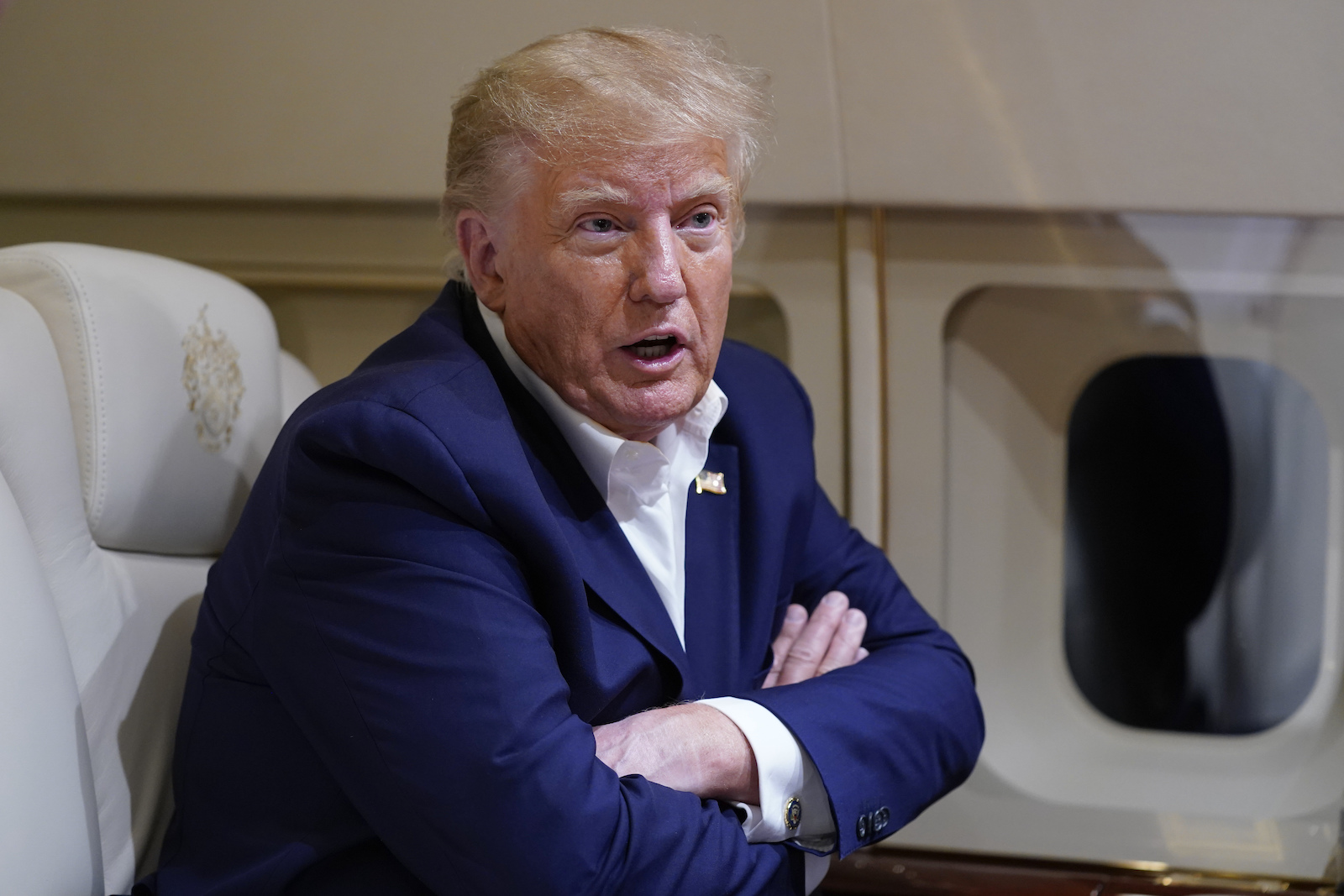 Donald Trump Former President Donald Trump speaks with reporters while in flight