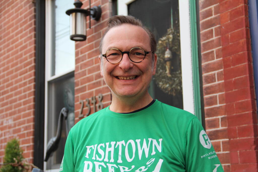 fishtown-beer-runners-1 David April smiles, posing outside of a red brick rowhome.