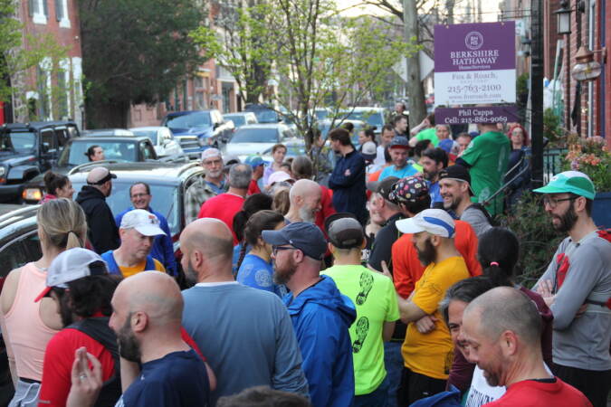 A view from above of a large group of people on a city street.