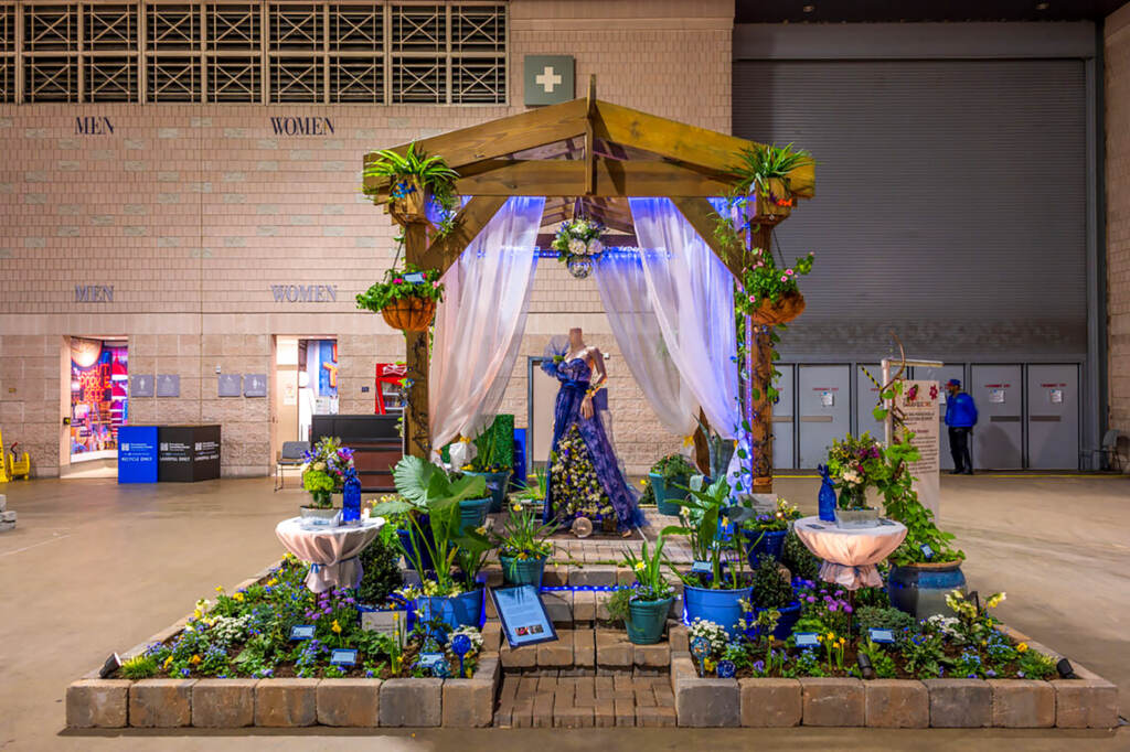 flowershow-wbsaul-highschool-04 A flower display has a blue gown as its centerpiece.