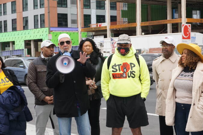 Bilal Qayyum speaks into a megaphone.