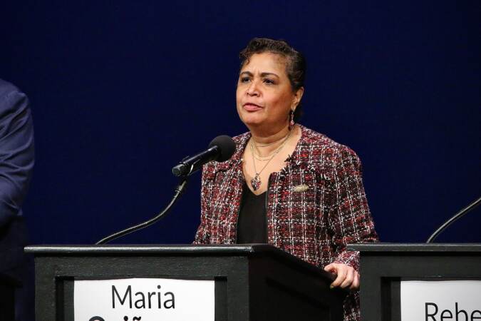 Maria Quiñones Sánchez at a podium