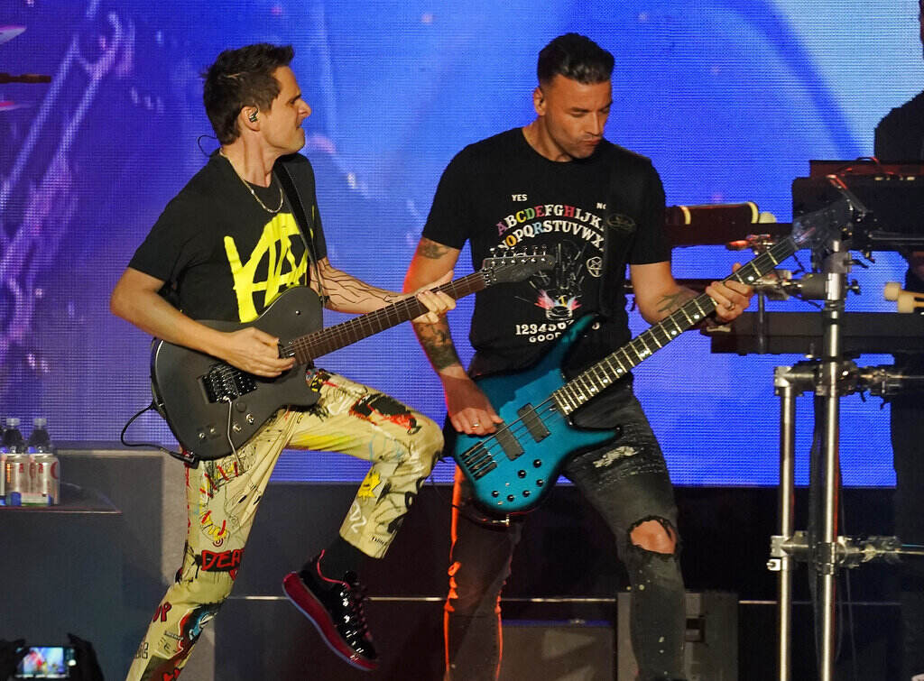 Matt Bellamy, Chris Wolstenholme Matt Bellamy and Chris Wolster play guitar onstage.