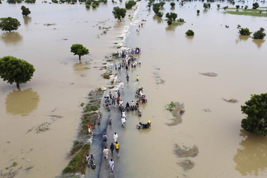UN Climate Report People walking through a heavily flooded area