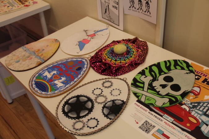 Eggs with different designs are laid out on a table.