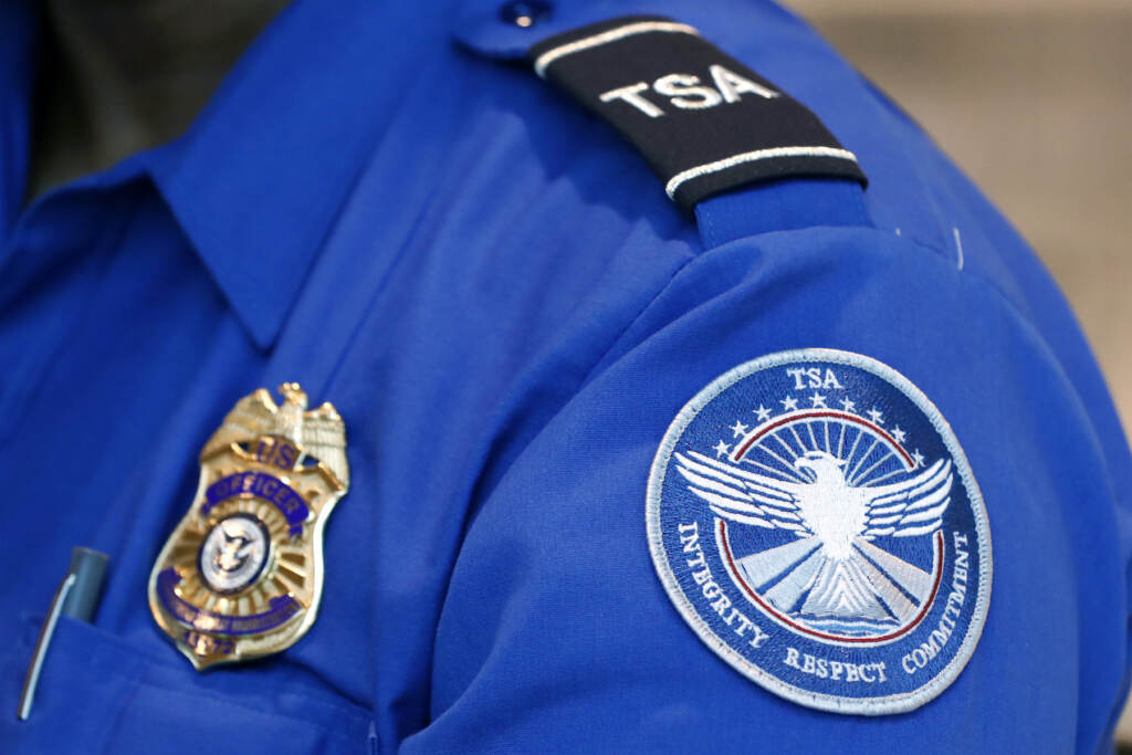 Pennsylvania Airport Explosive FILE - A Transportation Security Administration officer works at Dallas Love Field Airport on June 24, 2020, in Dallas. A man was arrested Monday, Feb. 27, 2023, after an explosive was found in a bag checked onto a Florida-bound flight at Lehigh Valley International Airport federal authorities said. (AP Photo/Tony Gutierrez, File)