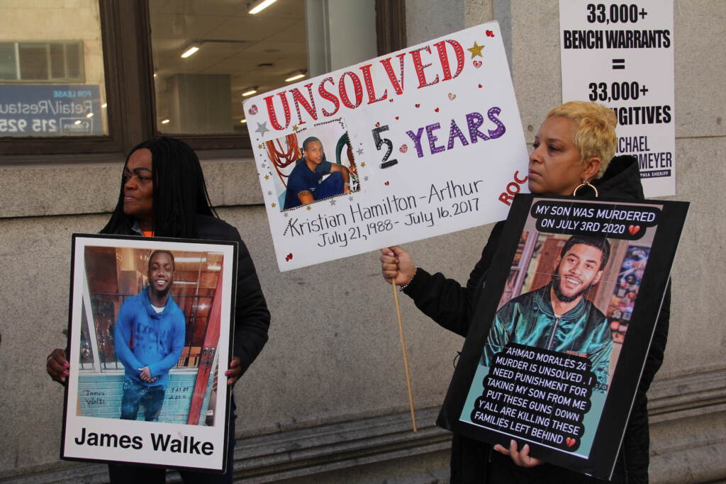 Victims of gun violence in Philadelphia hold signs supporting Untermeyer's campaign for Philadelphia sheriff.