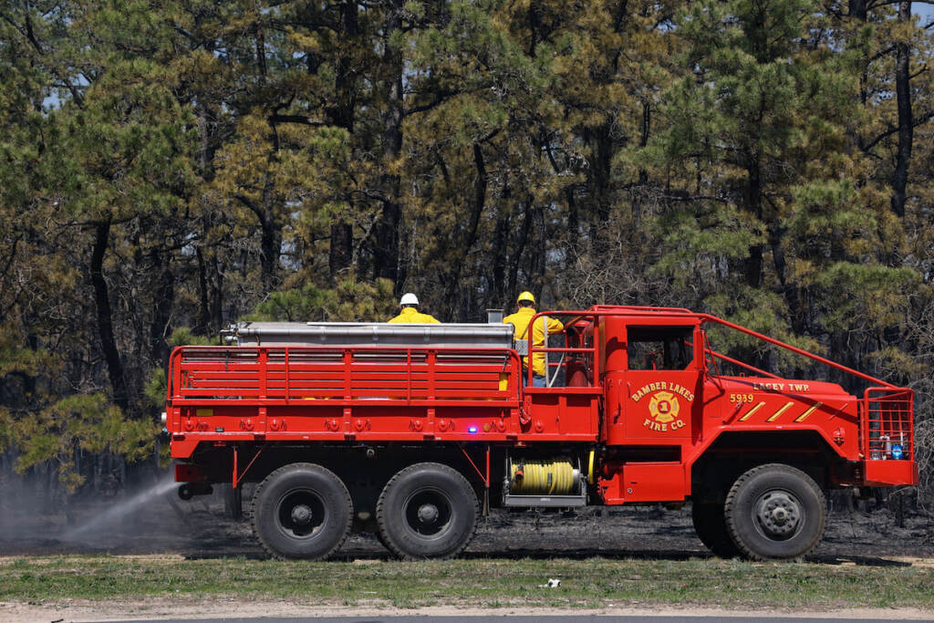 04 12 2023 KPAynter jimmy’s waterhole fire manchester township-2 A fire truck and firefighters are visible in front of a forest.