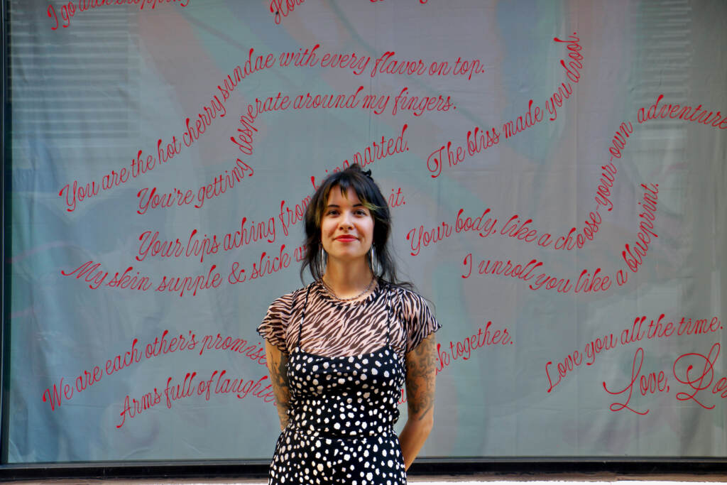 Eva Wu poses in front of a curtain.