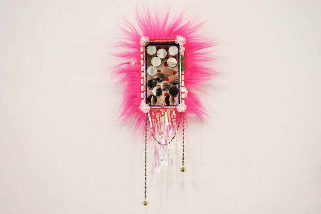 A box with decorations is hung on a wall.
