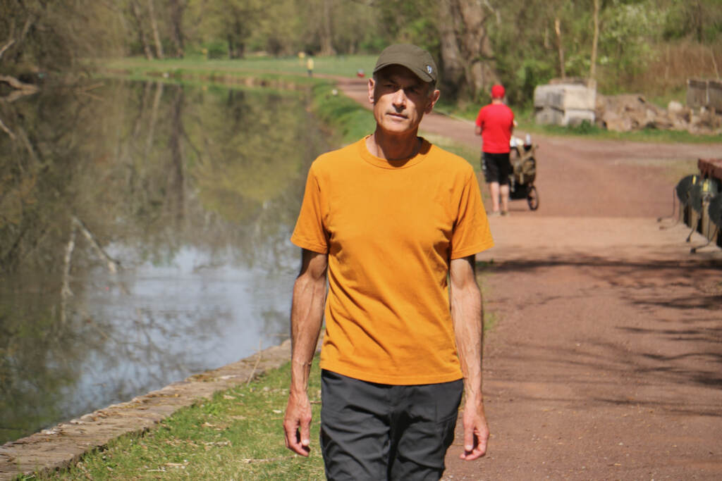 2023 04 14-e lee-neil king-new hope pa-american ramble walk Neil King walking on a path along a river.