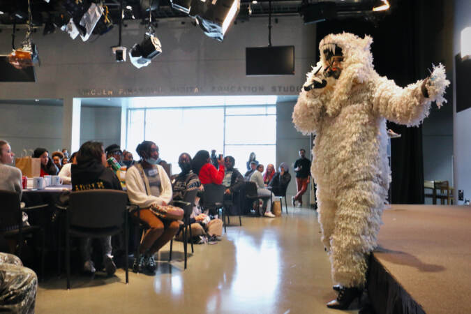 John Jarboe performs in a polar bear costume in front of a group of students.