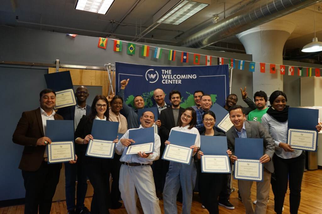 Participants in The Welcoming Center's International Professionals Program pose during a ceremony celebrating the program