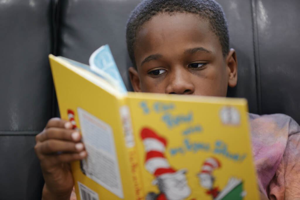 Learning To Read Young boy learning to read