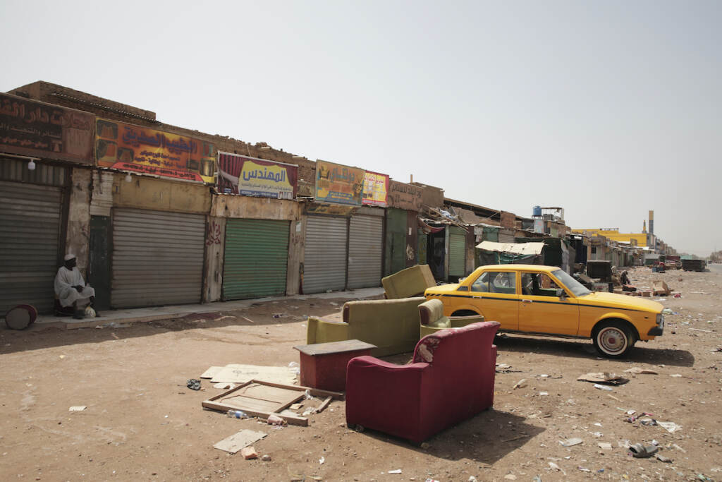 CORRECTION Sudan A man sits by shuttered shops in Khartoum