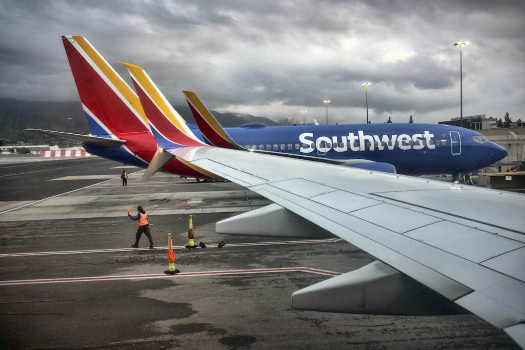Southwest Airlines A Southwest Airlines ground crew directs a plane out of the terminal at Hollywood Burbank Airport in Burbank