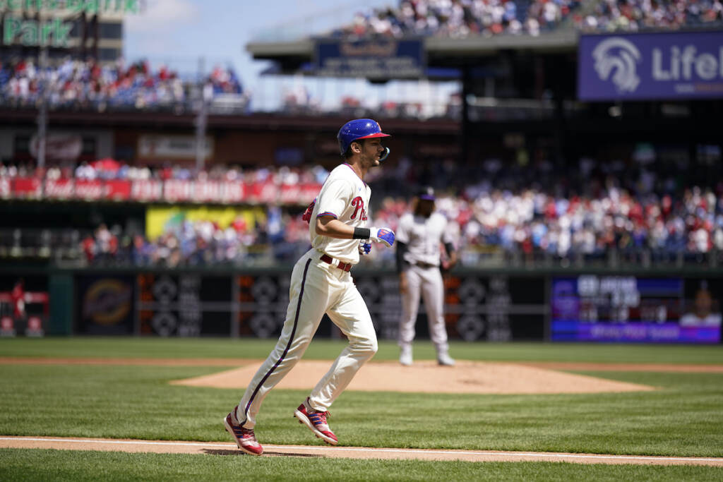 Philadelphia Phillies' Trea Turner (left) rounds the bases after hitting a home run against Colorado Rockies pitcher Jose Urena during the first inning of a baseball game, Sunday, April 23, 2023, in Philadelphia